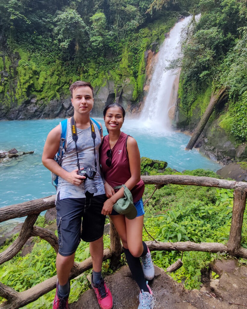 Travel couple in Rio Celeste Waterfall, Costa Rica