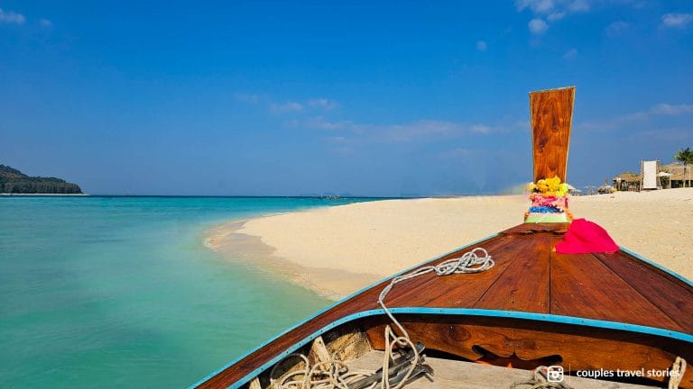 Boat docked in North Point beach with crystal-clear water of Koh Lipe, Thailand